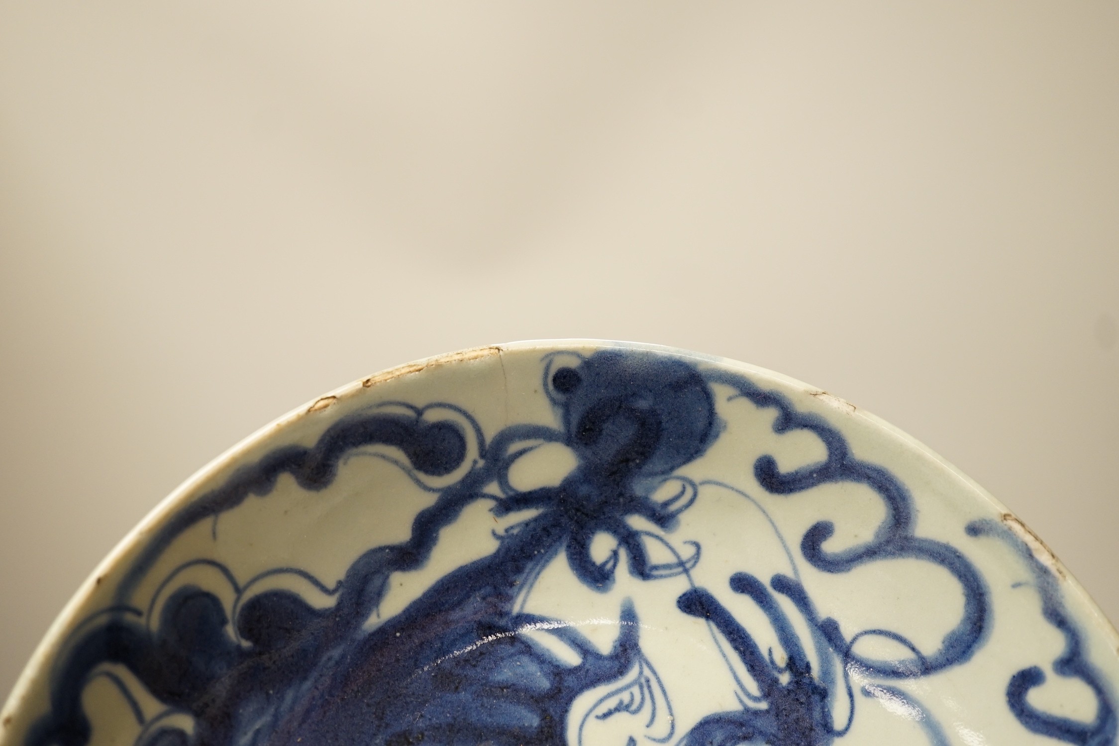 Two 19th century Chinese blue and white dishes and two 18th century tea bowls, largest 23cm diameter